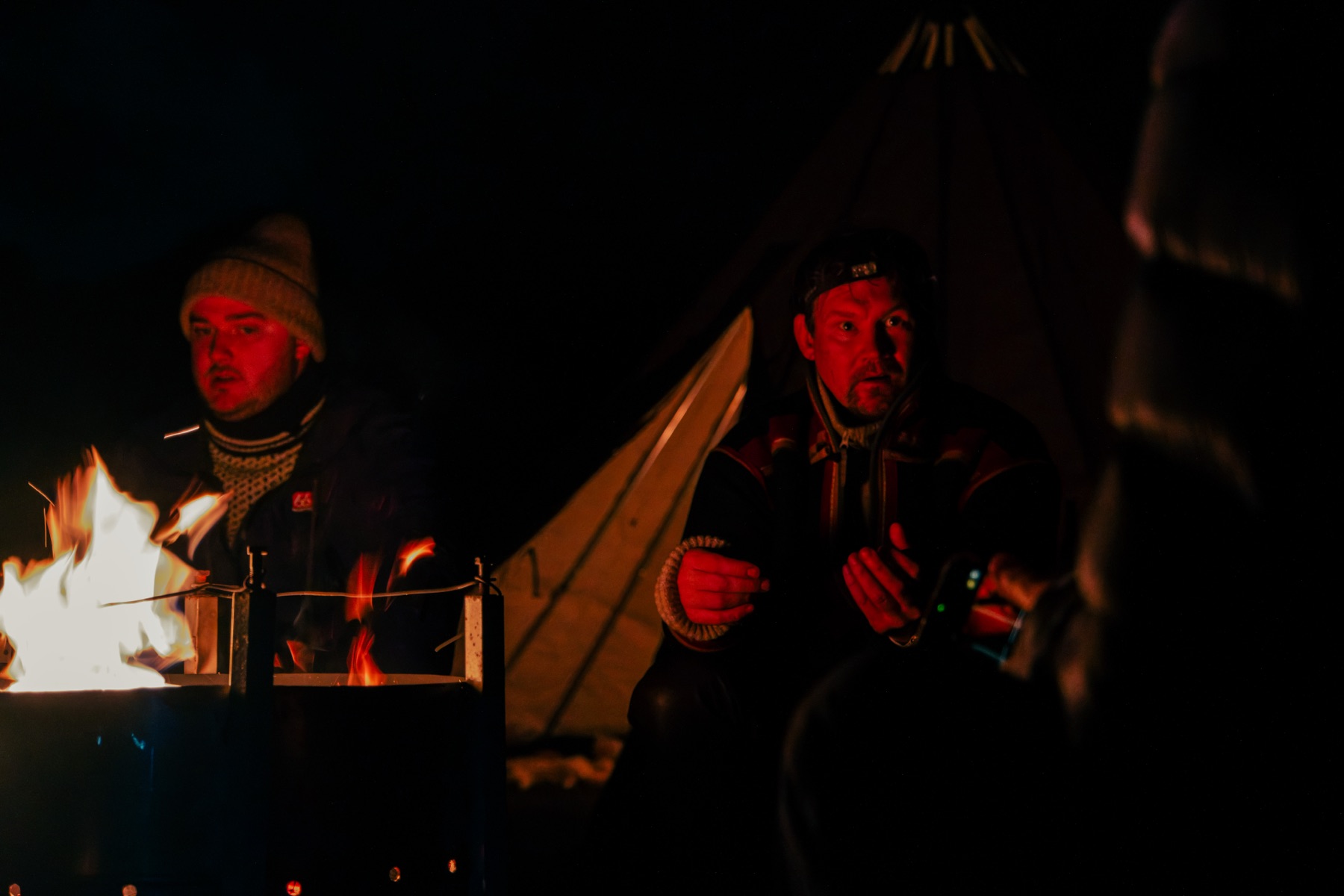 Odd Levi and Ole Mathis by the fire at night