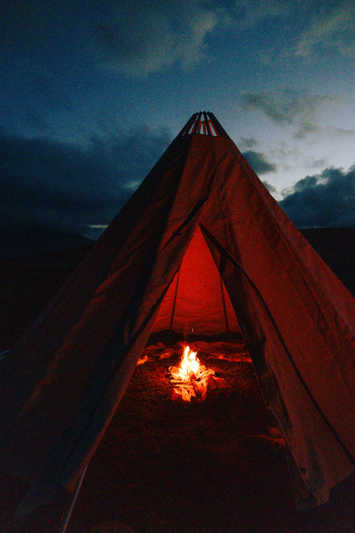 The lavvu lit from within at dusk